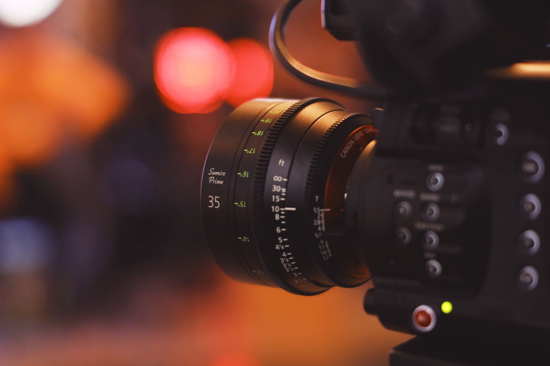 Close-up of a camera lens with cinematic bokeh background