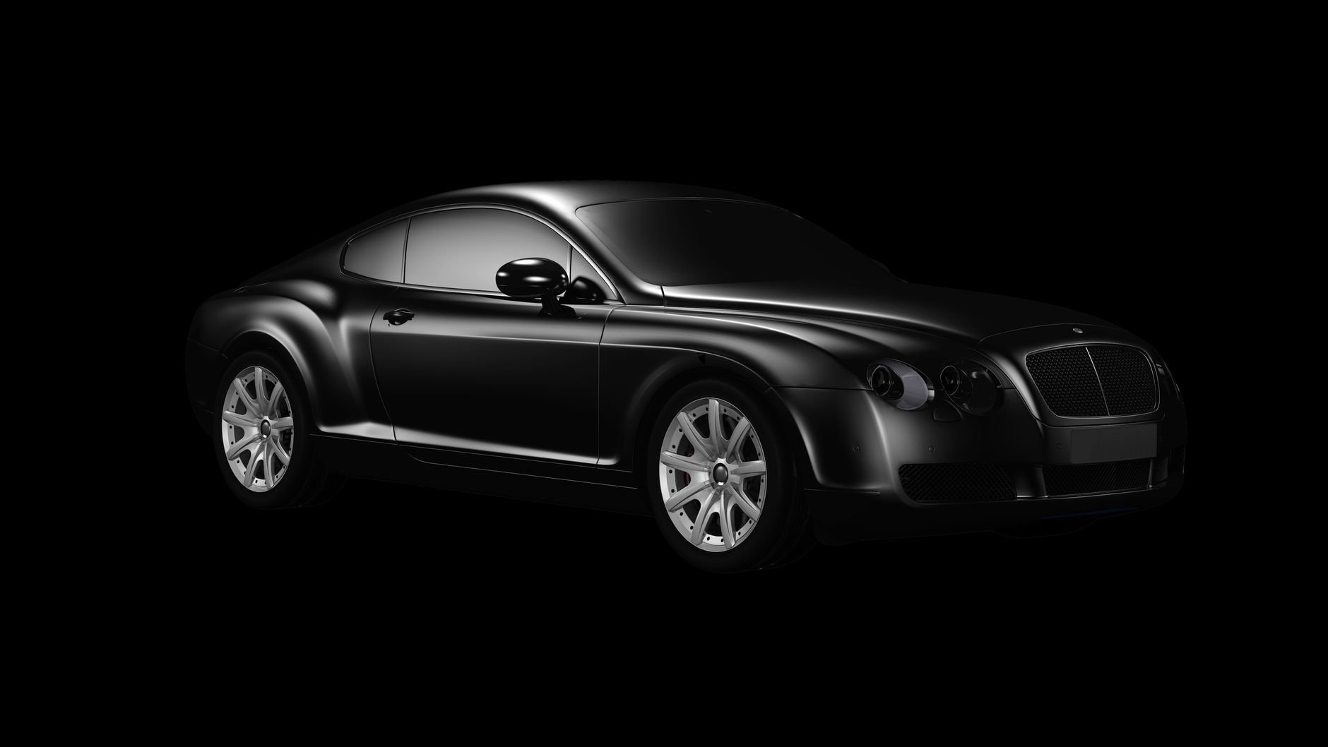 Black luxury car photographed in studio with sleek design and chrome accents