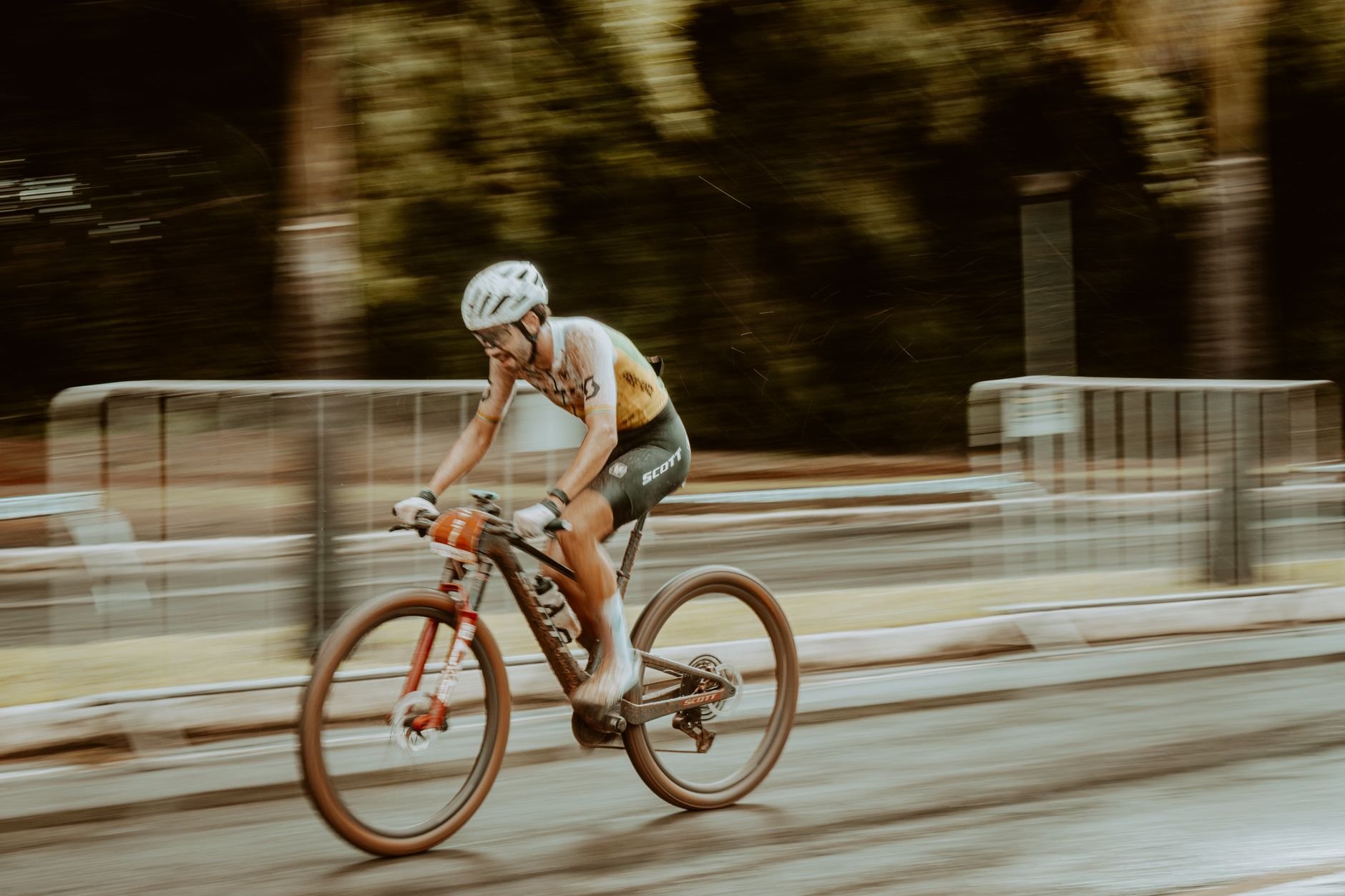 Blurred motion shot of a cyclist racing outdoors on a road